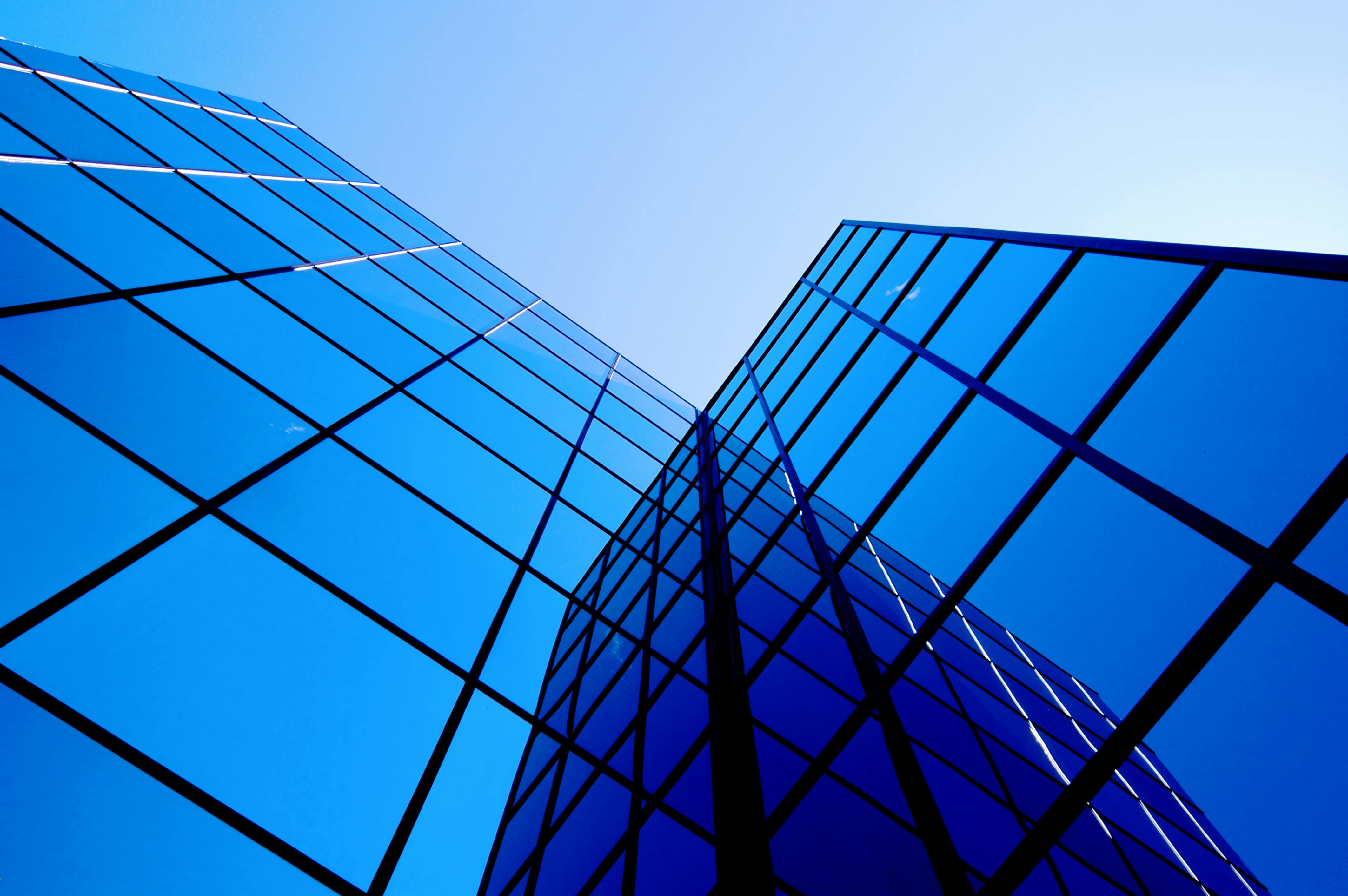 Office building windows. Office building details reflecting blue sky and clouds in windows