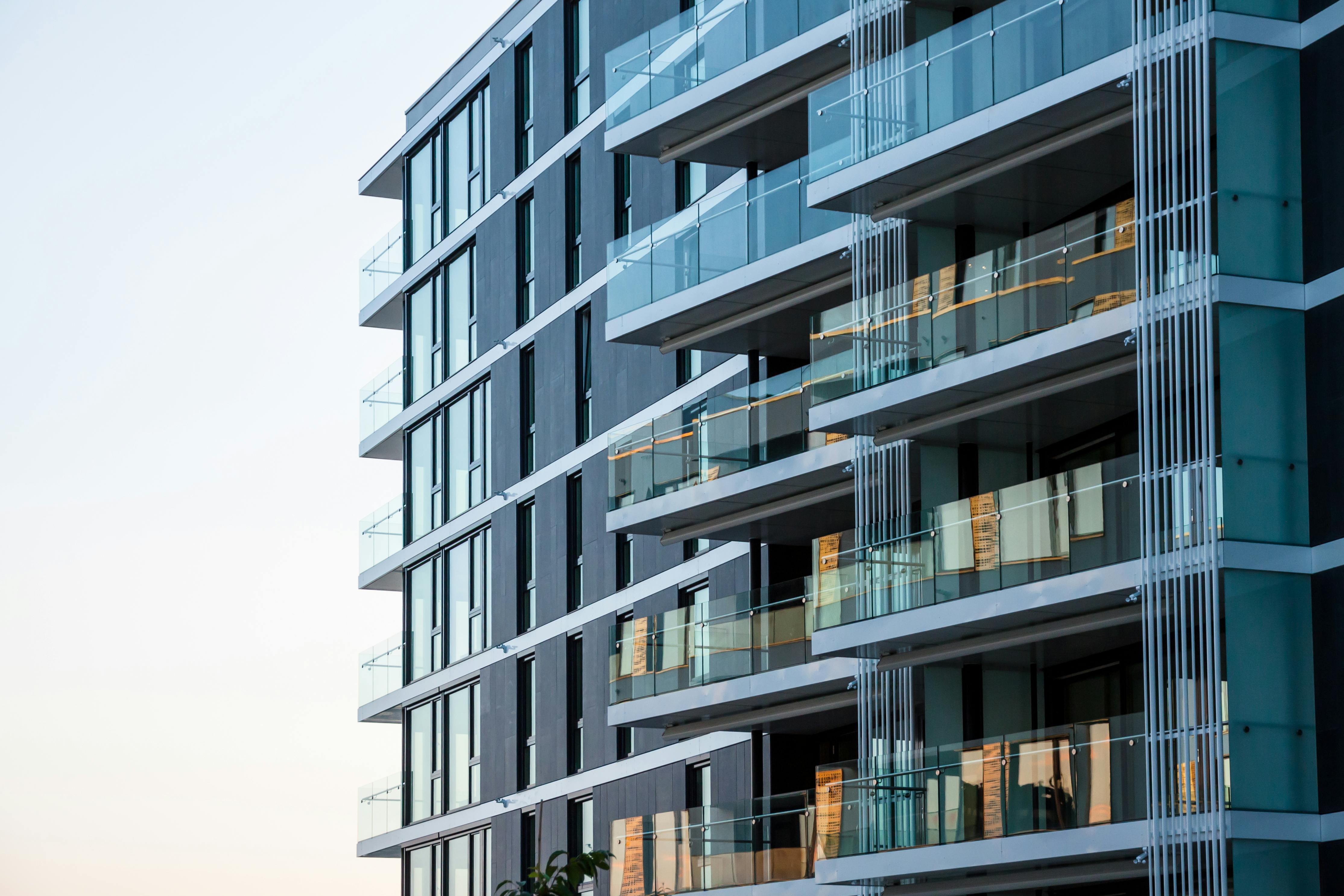 Outside view of modern apartments with glass terraces