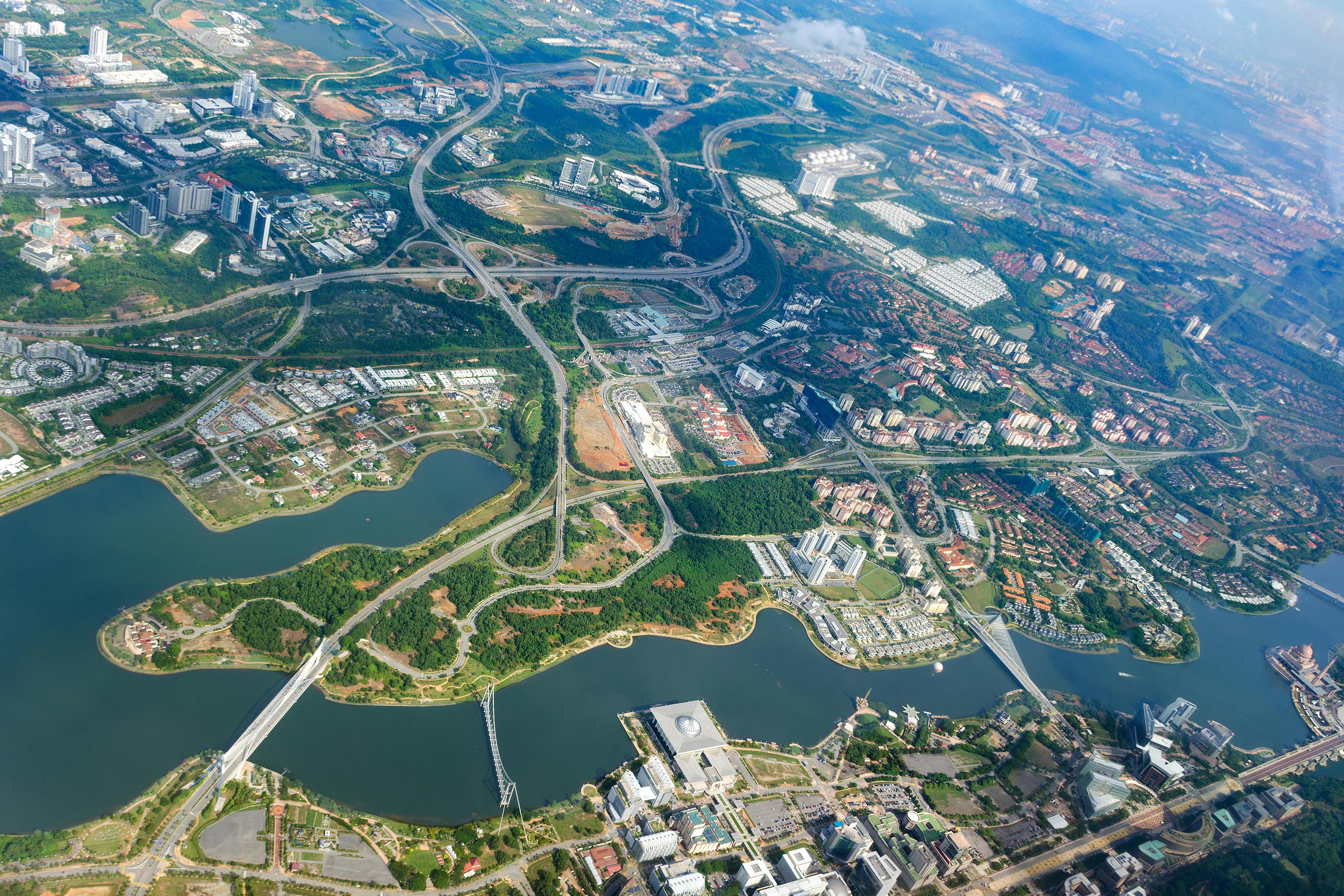 Overhead city view of Putrajaya. Aerial cityscape, Malaysia. Overhead city view of Putrajaya - Putra lake, Seri Saujana Bridge, Prime Minister`s Department Complex, Federal Government Administrative Centre, Putra Mosque.