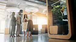Lobby, talking and business people in office for coworking space for collaboration, teamwork and discussion. Professional, corporate and men and women in meeting with cubicle for private workspace.