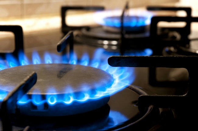 Gas stove. Closeup. Black gas stove and two burning flames close-up