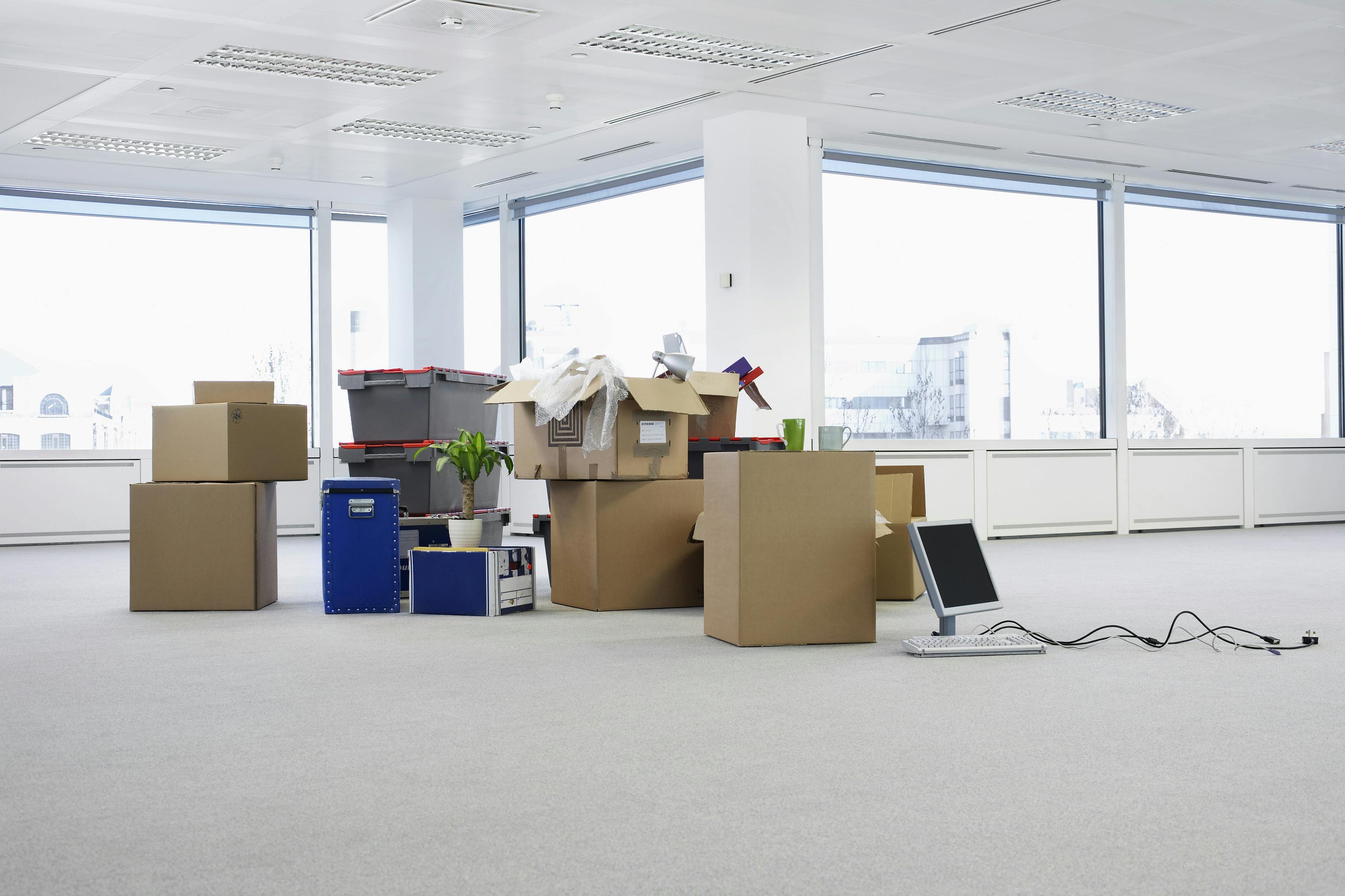 Empty Office With Boxes. Cartons and equipment on floor of empty office space