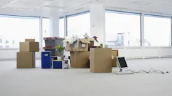 Empty Office With Boxes. Cartons and equipment on floor of empty office space