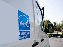 Energy Star sign. The Energy Star logo on the side of a machine repair truck in a parking lot. Energy Star sign. The Energy Star logo on the side of a machine repair truck in a parking lot.