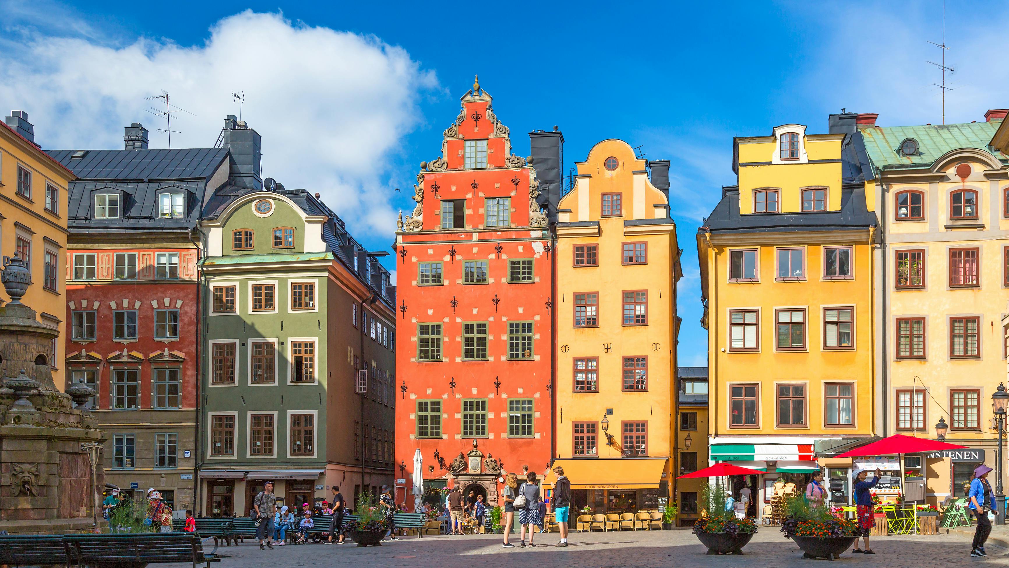 Stockholm, Sweden - July, 2018: Colorful facade of the houses in Stortorget Square Gamla Stan. Stockholm, Sweden with tourists at summer sunny day