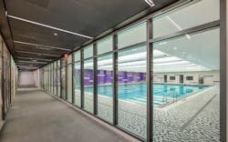 Transparent fire-resistive glass walls were used liberally in the exit corridors in the underground levels to achieve code compliance, spatial openness and enhanced wayfinding. Photo credit: SAFTI FIRST® Transparent fire-resistive glass walls were used liberally in the exit corridors in the underground levels to achieve code compliance, spatial openness and enhanced wayfinding. Photo credit: SAFTI FIRST®