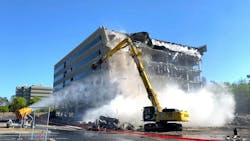 Swinerton’s Atlanta division is being tapped for significant redevelopment projects, particularly office to multifamily conversions. Swinerton started this redevelopment project using a 170,000-pound excavation monster, the Liebherr R 950, to eat a six-story office building. The building’s exterior, floors, and 30-inch structural columns were reduced to a pile of rubble. Swinerton will be recycling the original rebar and reusing 11,000 tons of concrete from the demolition in the redevelopment. Swinerton and Atlas Disposal, its partner and excavator operator, used four tractor trailers to transport the Liebherr R 950. Swinerton’s Atlanta division is being tapped for significant redevelopment projects, particularly office to multifamily conversions. Swinerton started this redevelopment project using a 170,000-pound excavation monster, the Liebherr R 950, to eat a six-story office building. The building’s exterior, floors, and 30-inch structural columns were reduced to a pile of rubble. Swinerton will be recycling the original rebar and reusing 11,000 tons of concrete from the demolition in the redevelopment. Swinerton and Atlas Disposal, its partner and excavator operator, used four tractor trailers to transport the Liebherr R 950.