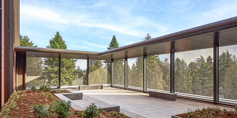 Metal mesh panels were used to safely restrict access and enclose an interior courtyard at the University of Washington Behavioral Health Center. Image courtesy of GKD-USA