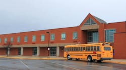 School Building with Bus. Red Brick School Building with Yellow School Bus at the front, ready for transporting students to home or drop off. School Building with Bus. Red Brick School Building with Yellow School Bus at the front, ready for transporting students to home or drop off.