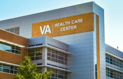 Veterans Administration Health Care Center. Horizontal, medium closeup of VA Health Care Center medical facilities exterior facade brand and logo signage adorning the modern architecture of the building in Charlotte, North Carolina with floors of reflective windows and a clear blue sky in the soft light of early morning. Veterans Administration Health Care Center. Horizontal, medium closeup of VA Health Care Center medical facilities exterior facade brand and logo signage adorning the modern architecture of the building in Charlotte, North Carolina with floors of reflective windows and a clear blue sky in the soft light of early morning.