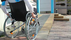 A Woman in a wheelchair using a ramp