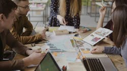 Young creative business team in modern office. Multiethnic group of people working on architectural design together. Coworking space for teamwork. Young creative business team in modern office. Multiethnic group of people working on architectural design together. Coworking space for teamwork.