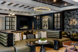 Moody colors and curved banquette seating bring a sense of intimacy and sophistication to the lounge at Park & Arbor, echoing the community’s boutique hotel-inspired aesthetic Moody colors and curved banquette seating bring a sense of intimacy and sophistication to the lounge at Park & Arbor, echoing the community’s boutique hotel-inspired aesthetic