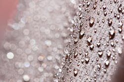 Waterproof textile fabric with rain drops. Waterproof and breathable textile fabric with rain drops on it Waterproof textile fabric with rain drops. Waterproof and breathable textile fabric with rain drops on it