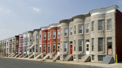 Colorful row houses along a residential street in Baltimore with painted brick and formstone facades and marble stoops. Colorful row houses along a residential street in Baltimore with painted brick and formstone facades and marble stoops.