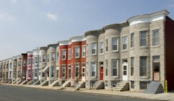 Colorful row houses along a residential street in Baltimore with painted brick and formstone facades and marble stoops. Colorful row houses along a residential street in Baltimore with painted brick and formstone facades and marble stoops.