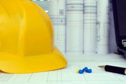 Construction project management tools - helmet, drawings and planning Construction project management tools - helmet, drawings and planning