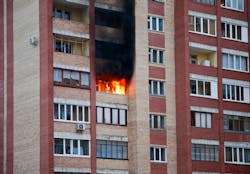 Fire in the multifamily house. Fire in one of the apartments of a large tenement-house Fire in the multifamily house. Fire in one of the apartments of a large tenement-house