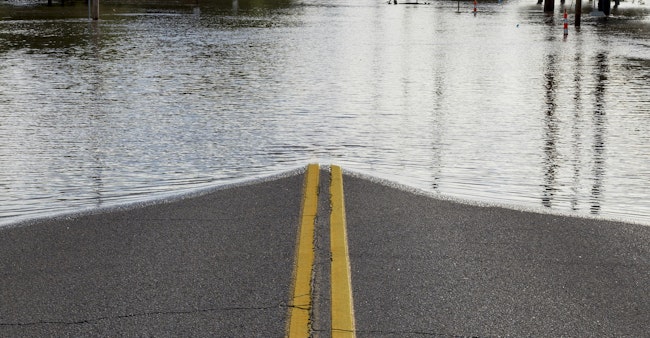Road Closure From Flooding. Road closed due to river flooding in neighborhood.
