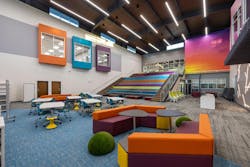 Vibrant colors inspired by Uvalde, Texas sunsets are found throughout the library. Flexible furniture is used as a tool to adapt space to teacher and student needs. A large learning stair offers assembly space. The view from the top overlooks the Memorial Tree Vibrant colors inspired by Uvalde, Texas sunsets are found throughout the library. Flexible furniture is used as a tool to adapt space to teacher and student needs. A large learning stair offers assembly space. The view from the top overlooks the Memorial Tree