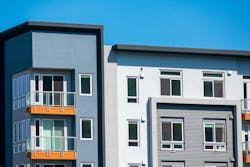 Exterior view of top level floors of typical new multifamily mid-rise residential building. The buildings usually rental apartments, college dorms, condominiums, or assisted-living facilities Exterior view of top level floors of typical new multifamily mid-rise residential building. The buildings usually rental apartments, college dorms, condominiums, or assisted-living facilities