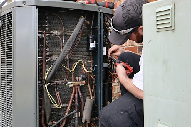 HVAC heat pump air conditioning unit being serviced