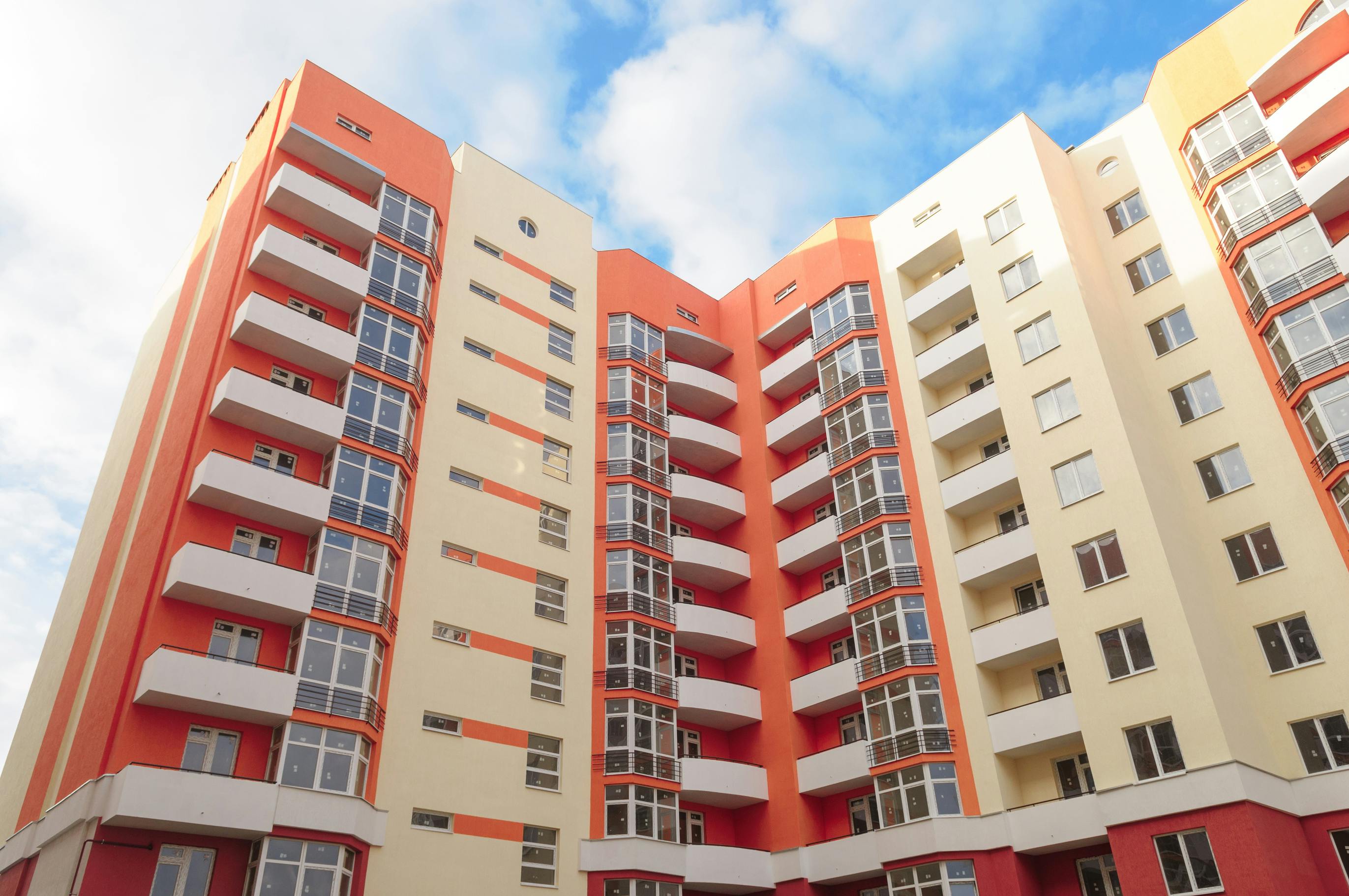 Modern apartment building on blue sky background