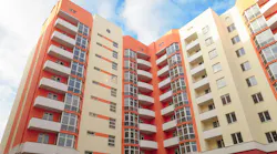 Modern apartment building on blue sky background