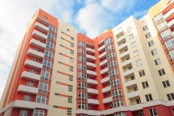 Modern apartment building on blue sky background Modern apartment building on blue sky background