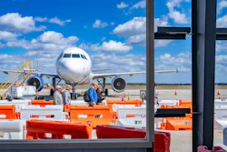 Airport passengers walking through Punta Gorda Airport Terminal Expansion construction Airport passengers walking through Punta Gorda Airport Terminal Expansion construction