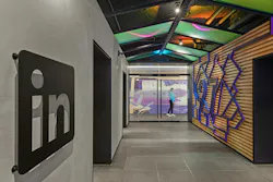 The LinkedIn Toronto office is designed around a sense‑making journey. The arrival identifiers establish orientation, the information desk provides reassurance, and wayfinding signage and large‑scale mural graphics help visitors navigate and remember the space. Photo courtesy CannonDesign The LinkedIn Toronto office is designed around a sense‑making journey. The arrival identifiers establish orientation, the information desk provides reassurance, and wayfinding signage and large‑scale mural graphics help visitors navigate and remember the space. Photo courtesy CannonDesign