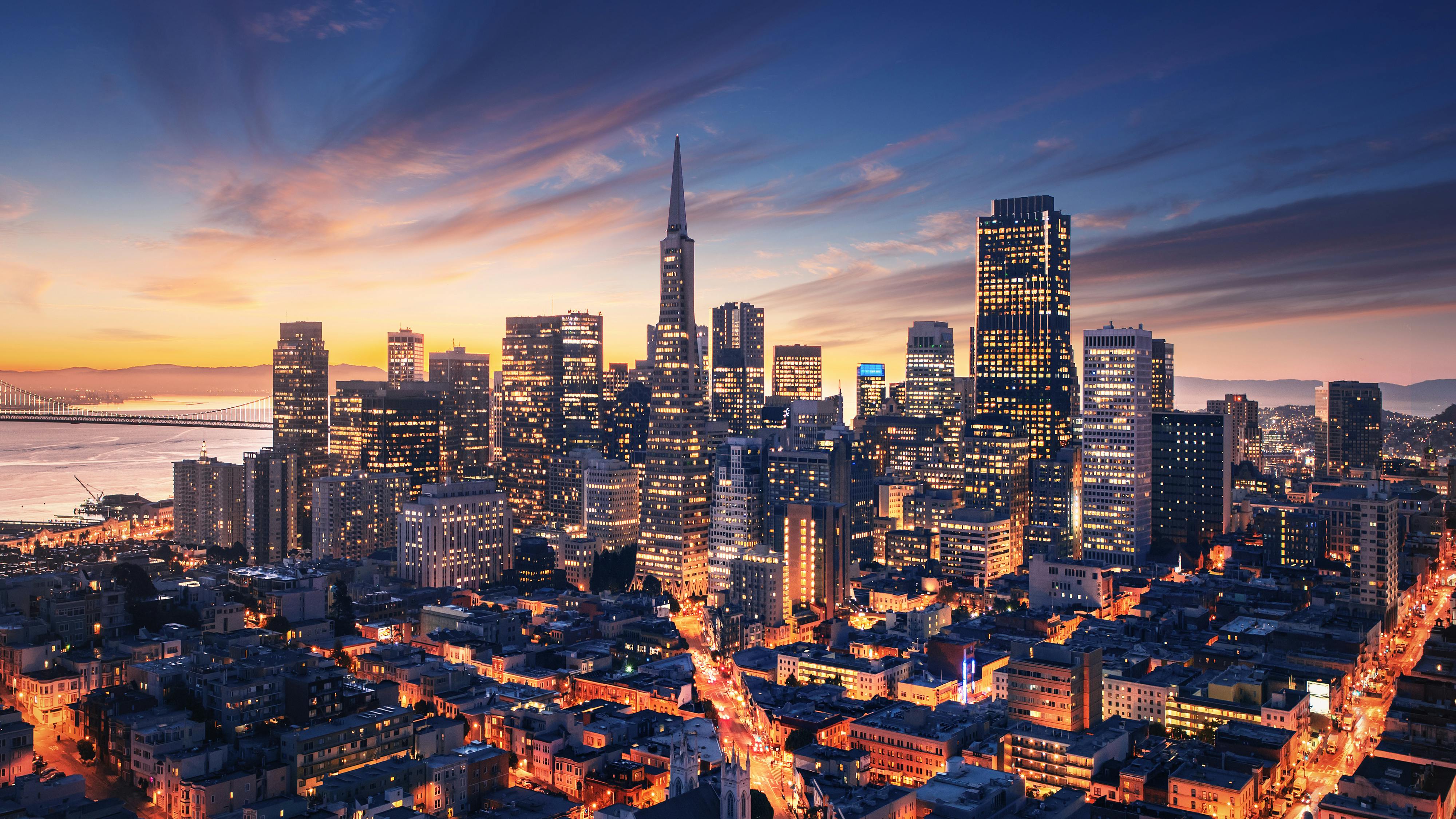 San Francisco aerial view from sea side. Port of San Francisco in the front. City downtown and skyscrapers at sunrise.