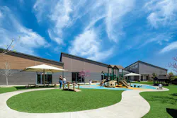 The Sam’s Club Kids Club exterior in Bentonville, Ark., conveys simplicity and approachability using natural materials, expansive glazing, and a low, child-scaled profile. The design enhances wayfinding and brings in daylight, illustrating how architecture can reduce stress and help establish a daily rhythm for parents, children, and caregivers alike. Photo © Albert Vecerka/Esto The Sam’s Club Kids Club exterior in Bentonville, Ark., conveys simplicity and approachability using natural materials, expansive glazing, and a low, child-scaled profile. The design enhances wayfinding and brings in daylight, illustrating how architecture can reduce stress and help establish a daily rhythm for parents, children, and caregivers alike. Photo © Albert Vecerka/Esto