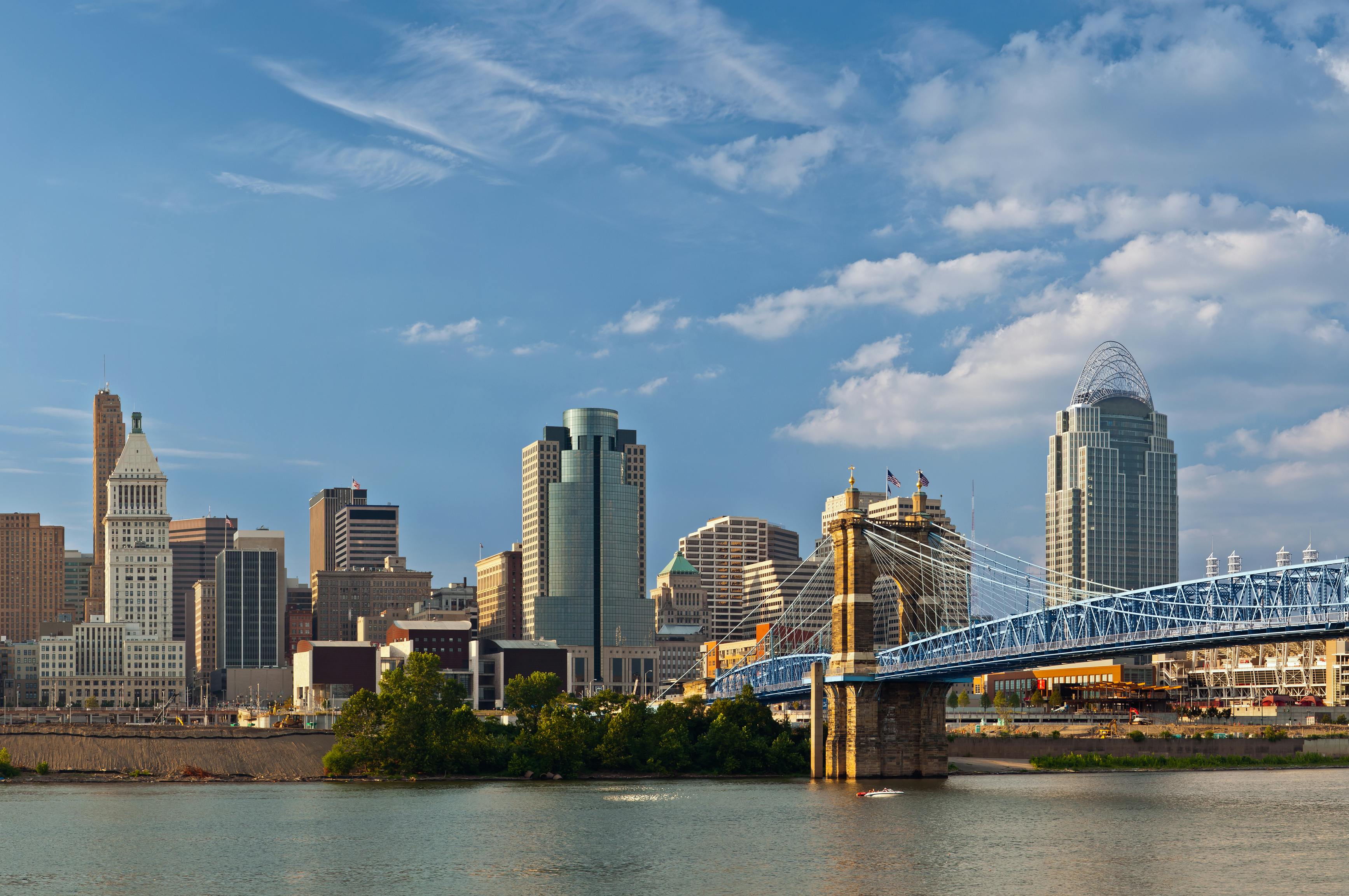 Cincinnati skyline. Image of Cincinnati skyline and historic suspension bridge cross Ohio River.