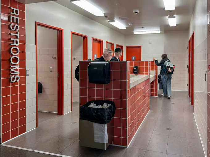 Single‑user restrooms at Graham‑Kapowsin High School are located off a main hallway in one wing, integrating universal access into daily student movement. Photo &copy; NAC Architecture