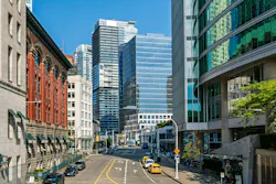 View of Cordova Street in downtown Vancouver during summer with buildings and vehicles. Vancouver, BC, Canada – July 19, 2026: Cordova Street in downtown Vancouver on a summer day. Tall buildings frame the street while cars and taxis are parked along the sides. The sky is clear and blue, adding a bright backdrop to the urban view. People can be seen walking along the sidewalks as they enjoy the warm weather