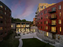 The glass-walled Connector links Coleman House with Opus, uniting residents of different income levels in shared spaces for dining, wellness, and celebration. Photo © Andrew Rugge