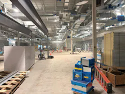 Early construction of the “building within a building” strategy establishes the controlled environments required for clean-room operations inside the existing warehouse shell. Photo courtesy RDG Planning & Design