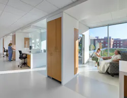 Cancer care patient area with daylight streaming in, private rooms, and light colors